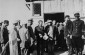 Two camp guards supervise a group of Jewish forced laborers from the Wisznice ghetto while they stand in line for food at the Horodyszcze labor camp. ©  United States Holocaust Memorial Museum, courtesy of Eliezer & Jenelly Rosenberg