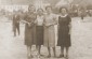 Group portrait of four young Jewish women in a public square in Łańcut, Poland. From left: Ethel Ringelheim, Sheila Gurfein, Esther Amet and Basia Gurfein. © United States Holocaust Memorial Museum, courtesy of Betty Gurfein Berliner