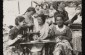 1939. A group of Jewish girls attend a sewing class in Kolbuszowa.From left to right: Wiesenfeld, a Polish girl, and Genia Nussbaum. Standing on the right is the teacher. ©Photo Credit: United States Holocaust Memorial Museum, courtesy of Norman Salsitz