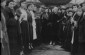 At the 'khupe' (ceremonial wedding canopy) at an outdoor wedding. The bride (center) faces us between two rows of celebrants holding lit candles.January 1924 © From the Archives of the YIVO Institute for Jewish Research