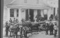 On the porch, in front of an inn. The photographer explains, "In this very house Yiddish theater has been performed--the best American Yiddish performers, originally from Russia and Rumania. 1920s© From the Archives of the YIVO Institute for Jewish Resear