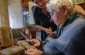 Musia G., born in 1938, showing family pictures to the Yahad team. © Les Kasyanov/Yahad - In Unum