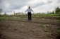 Petru B., born in 1928, showing the YIU team the execution site of the Jews from Grimăncăuți. The mass grave had been dug by the victims themselves before the execution. © Kate Kornberg/ Yahad - In Unum